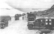 (details) Probably in the very first days after June 6 (details) A convoy goes back through Vierville. These GMCs may have landed from the stranded LST on the beach.