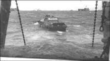 (details) DUKW coming out of an LST Ducks carrying supplies are approaching the coast